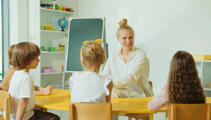 A teacher engages directly with students during a focused lesson.